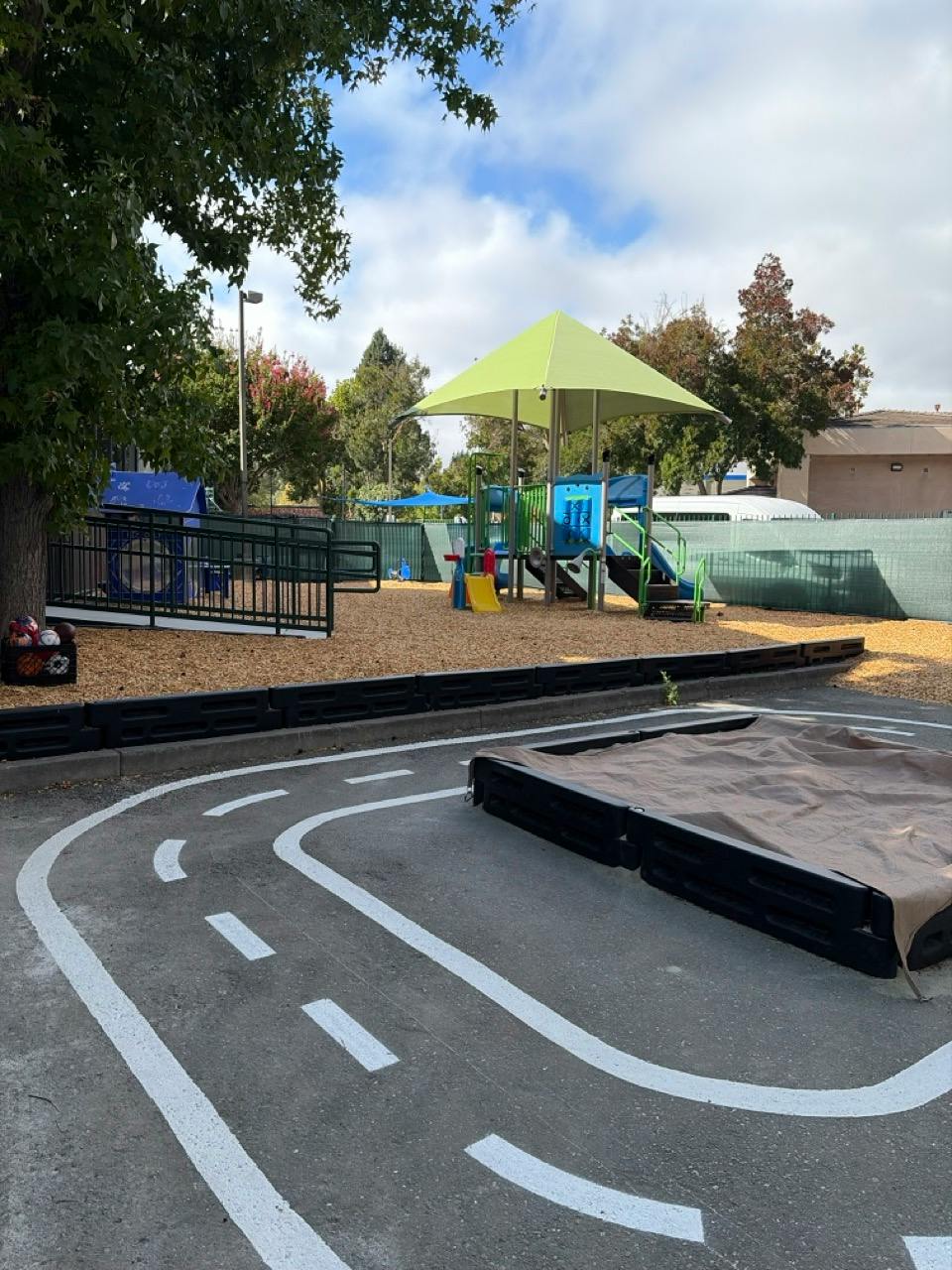 Playground with climbing structure and sandbox track