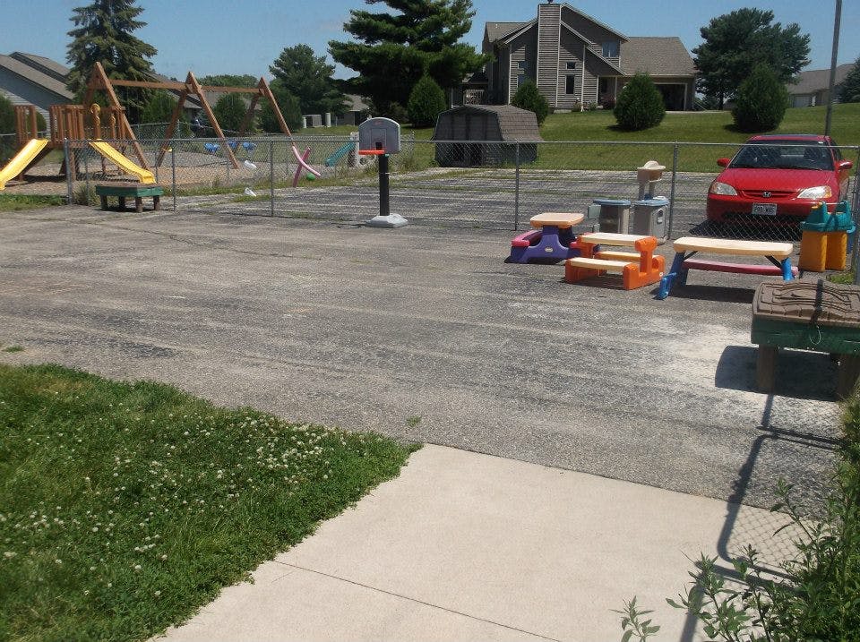Playground with swings, slides, and a basketball hoop