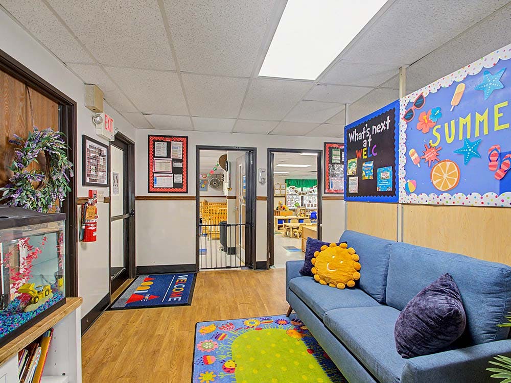 Lobby area with a blue sofa and two bulletin boards