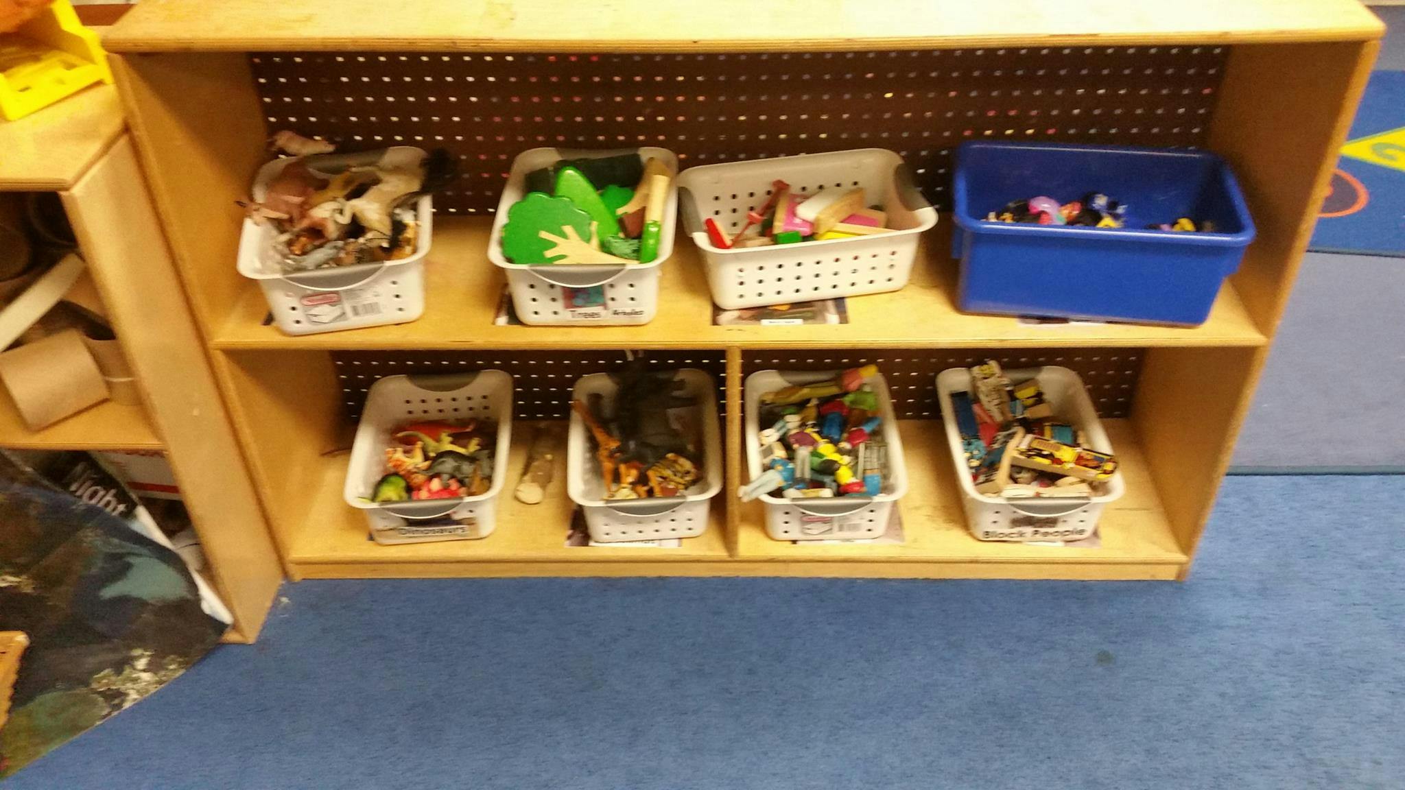 Wooden shelf with baskets and bins of toys