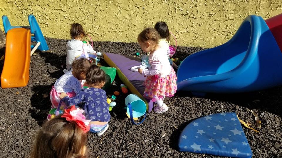 Children playing on a playground with slides