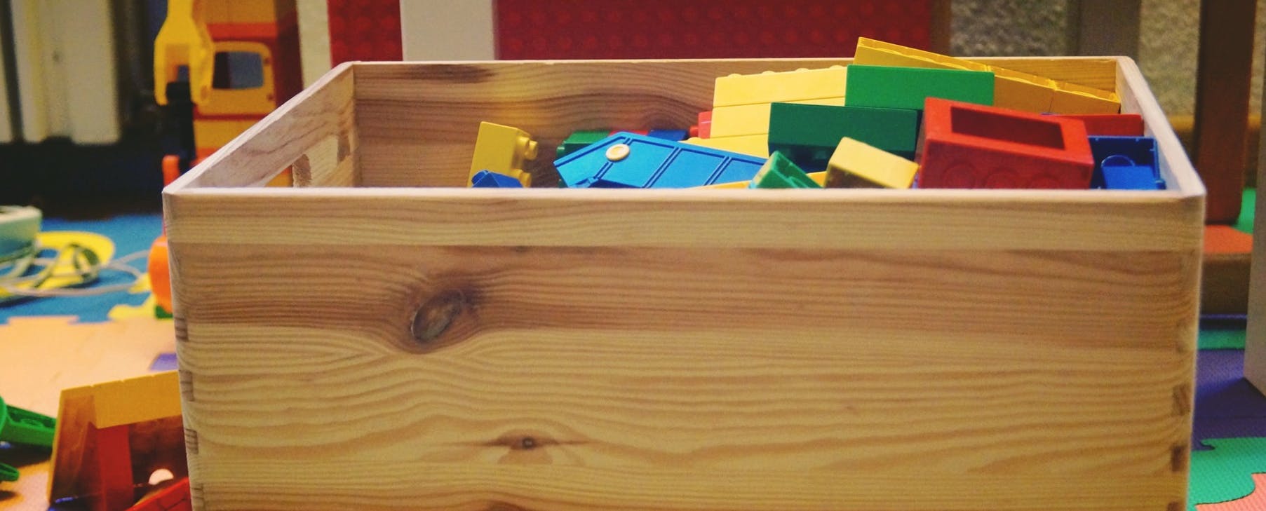 Wooden box filled with colorful building blocks