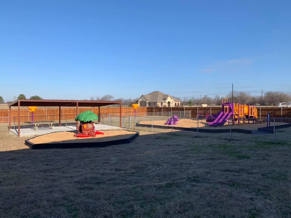 Outdoor playground with sandboxes, slides, and play structures