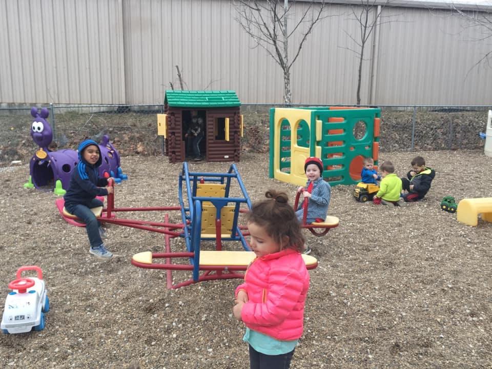 Children playing on playground equipment outdoors