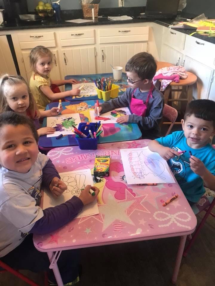 Children coloring at a table
