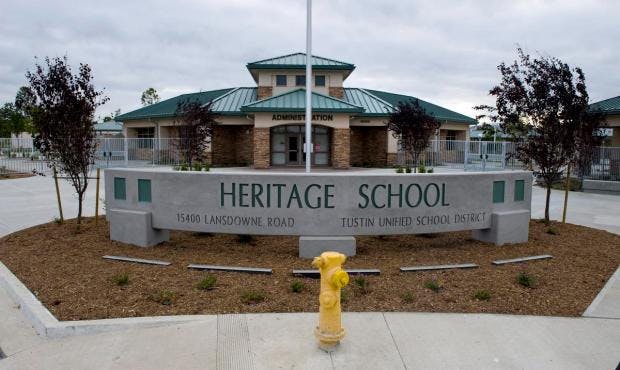 Heritage School sign in front of a building