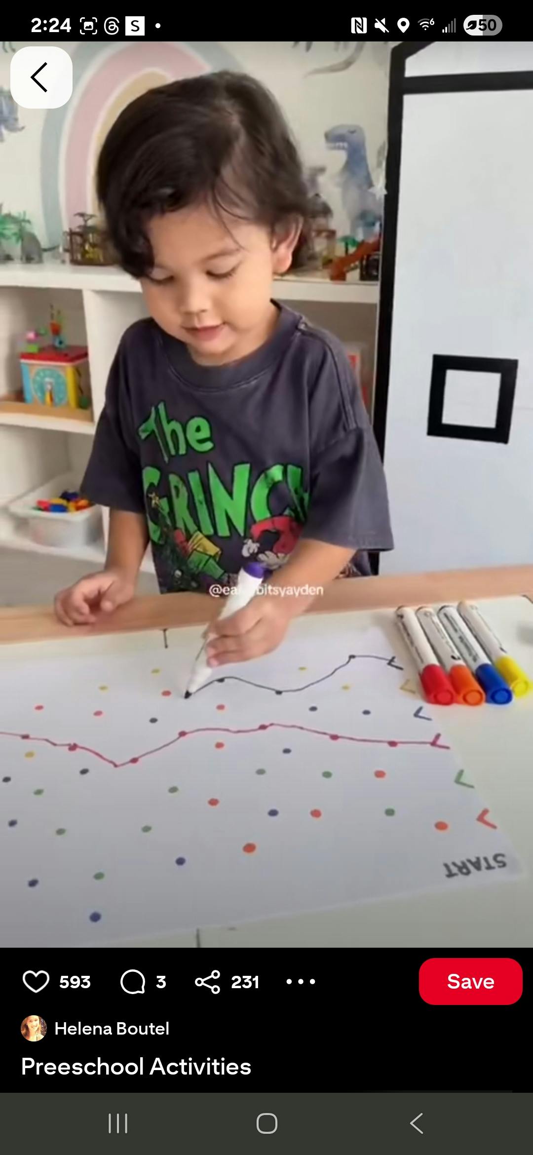 Child drawing on paper with a marker