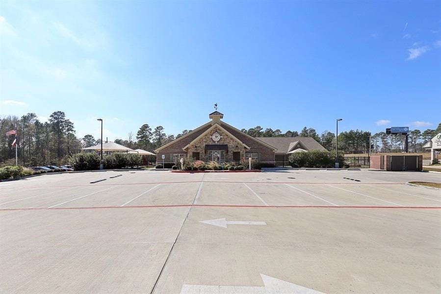 Building with a large parking lot in front