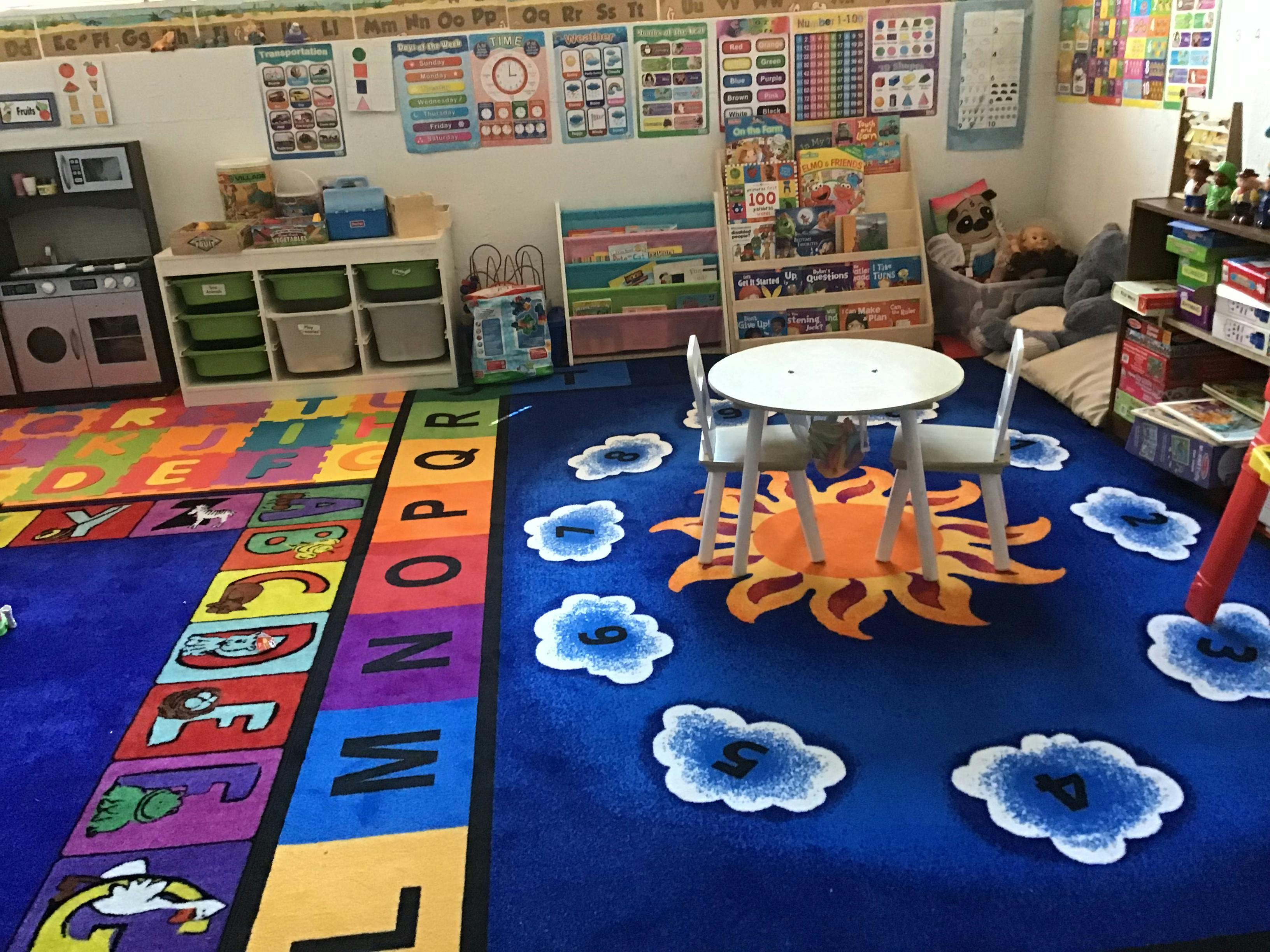 Classroom with alphabet rug and small table with chairs