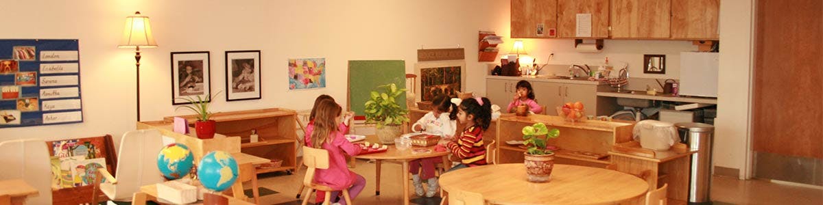 Children sitting at tables in a classroom
