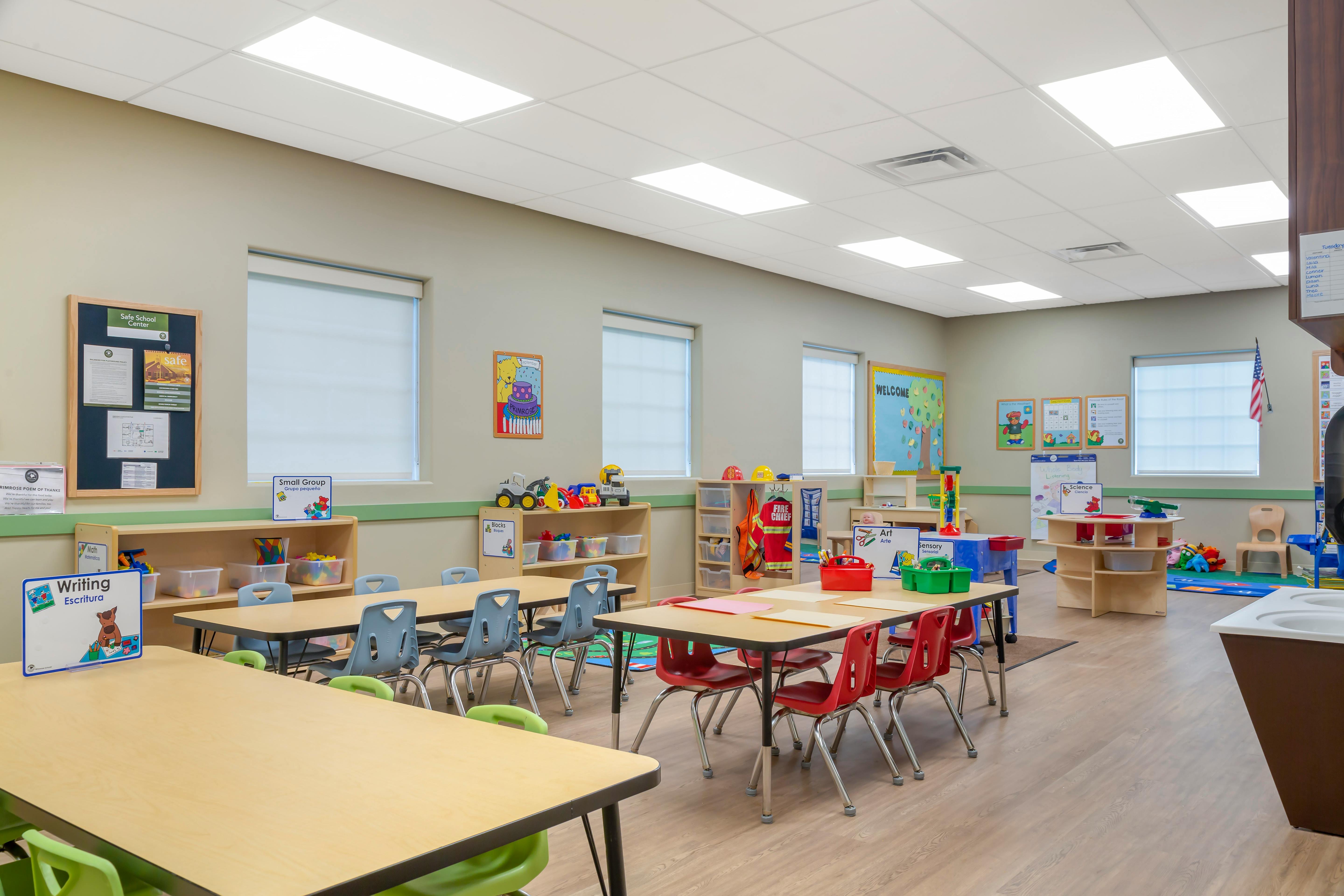 Classroom with tables, chairs, and learning stations