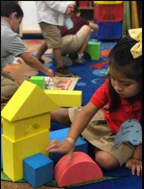 Child playing with colorful blocks on the floor