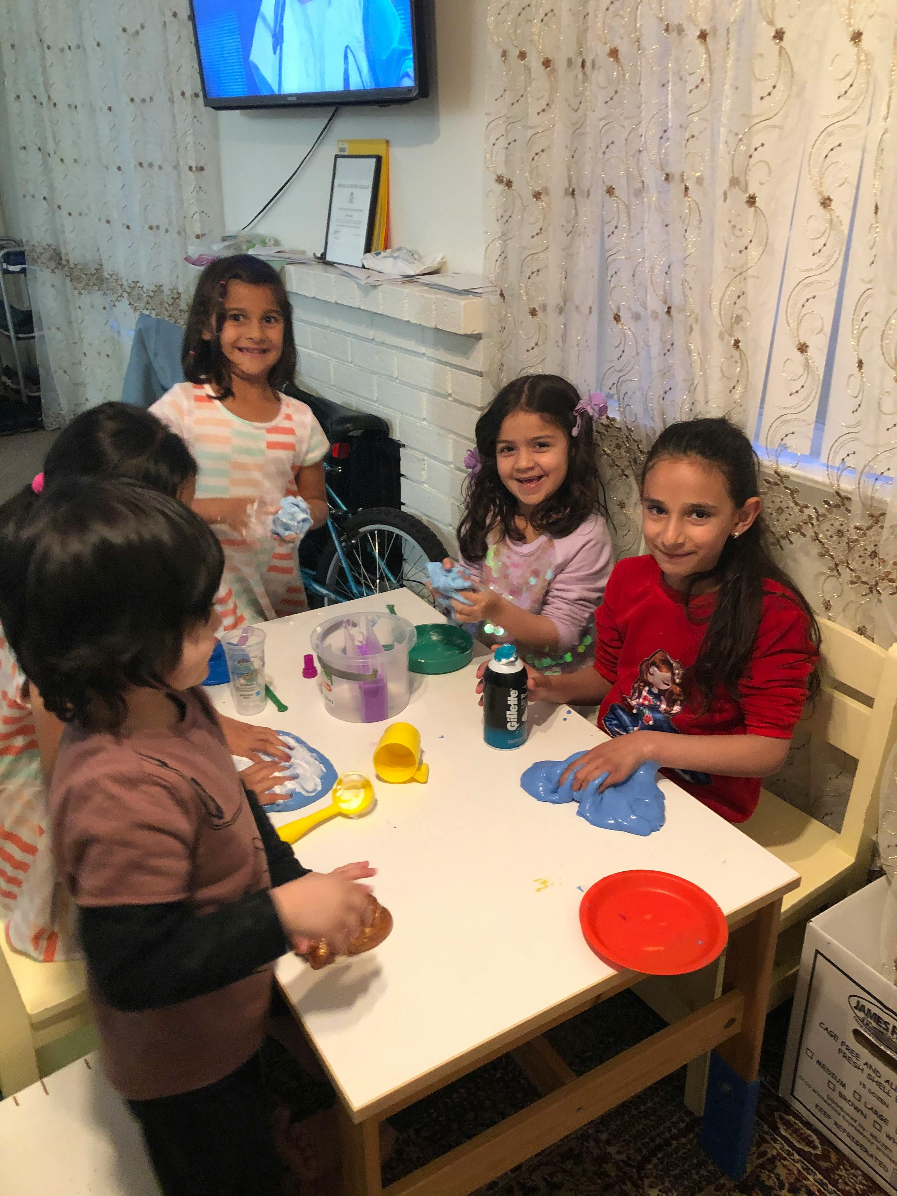 Children playing with slime at a table