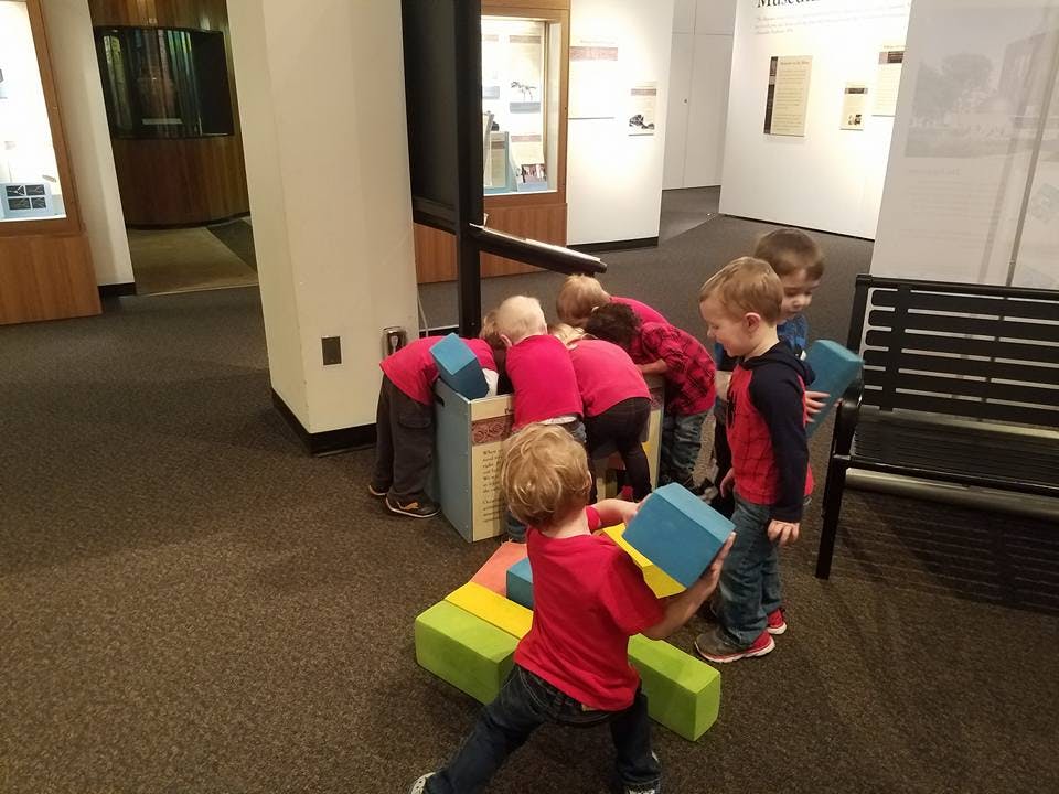 Children playing with large building blocks