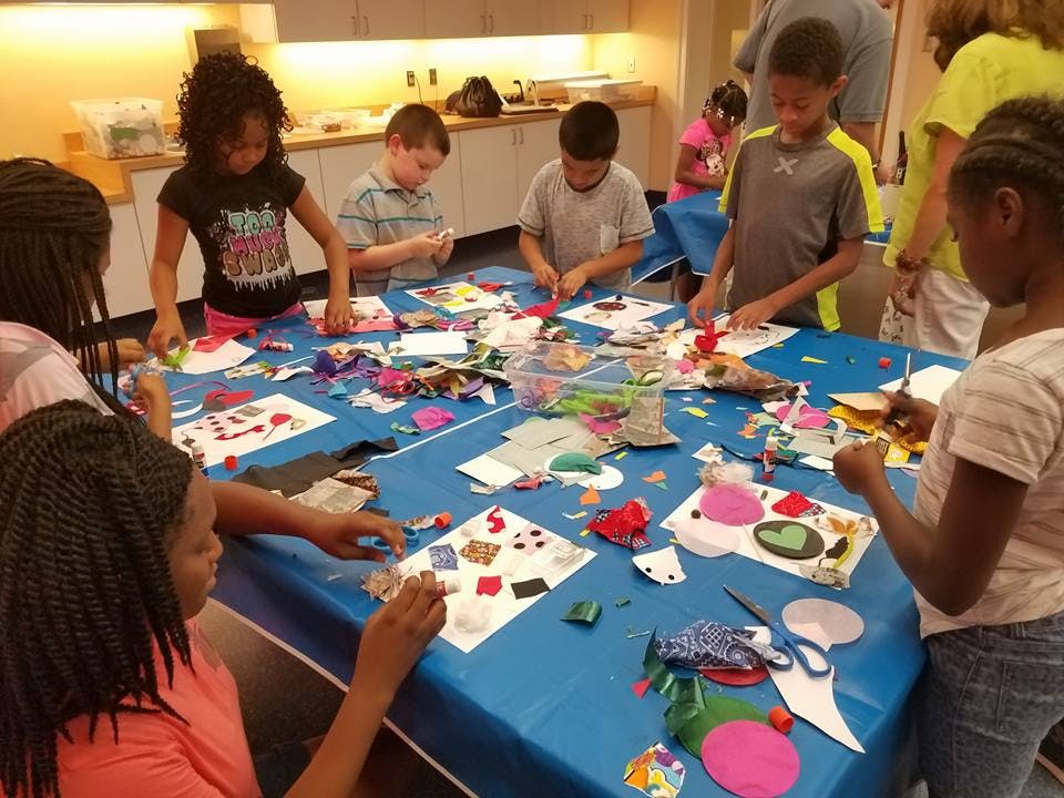 Children making crafts at a table