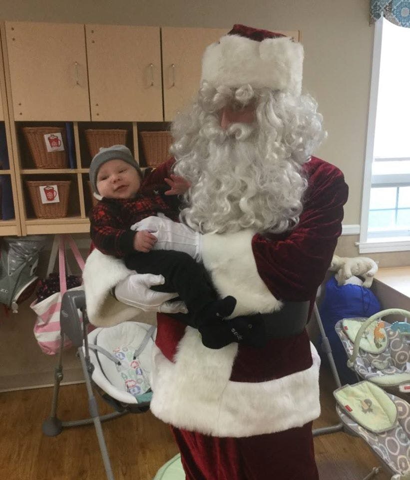 Person dressed as Santa holding a child