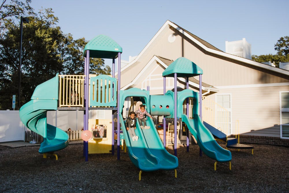 Two children on a playground slide