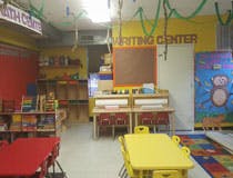 Empty classroom with small tables and chairs