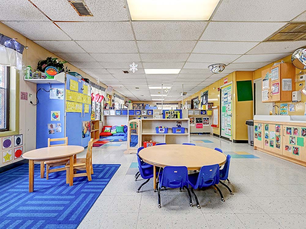 Empty classroom with small tables and chairs
