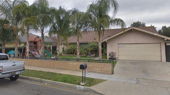 House with a garage and palm trees in front
