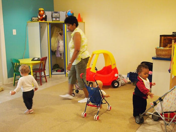 Adult and children in a room with toys