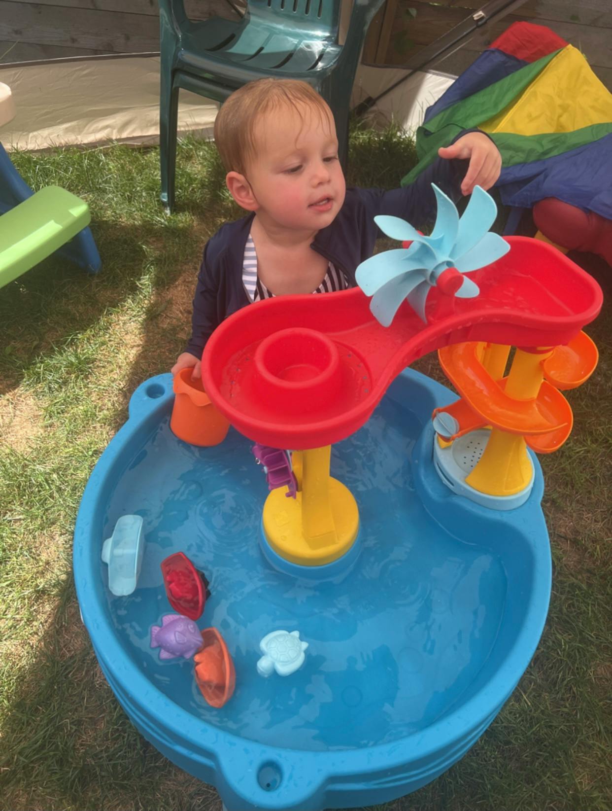 Child playing with a water table