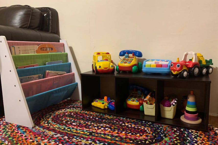 Toy shelf with various toys and a book display