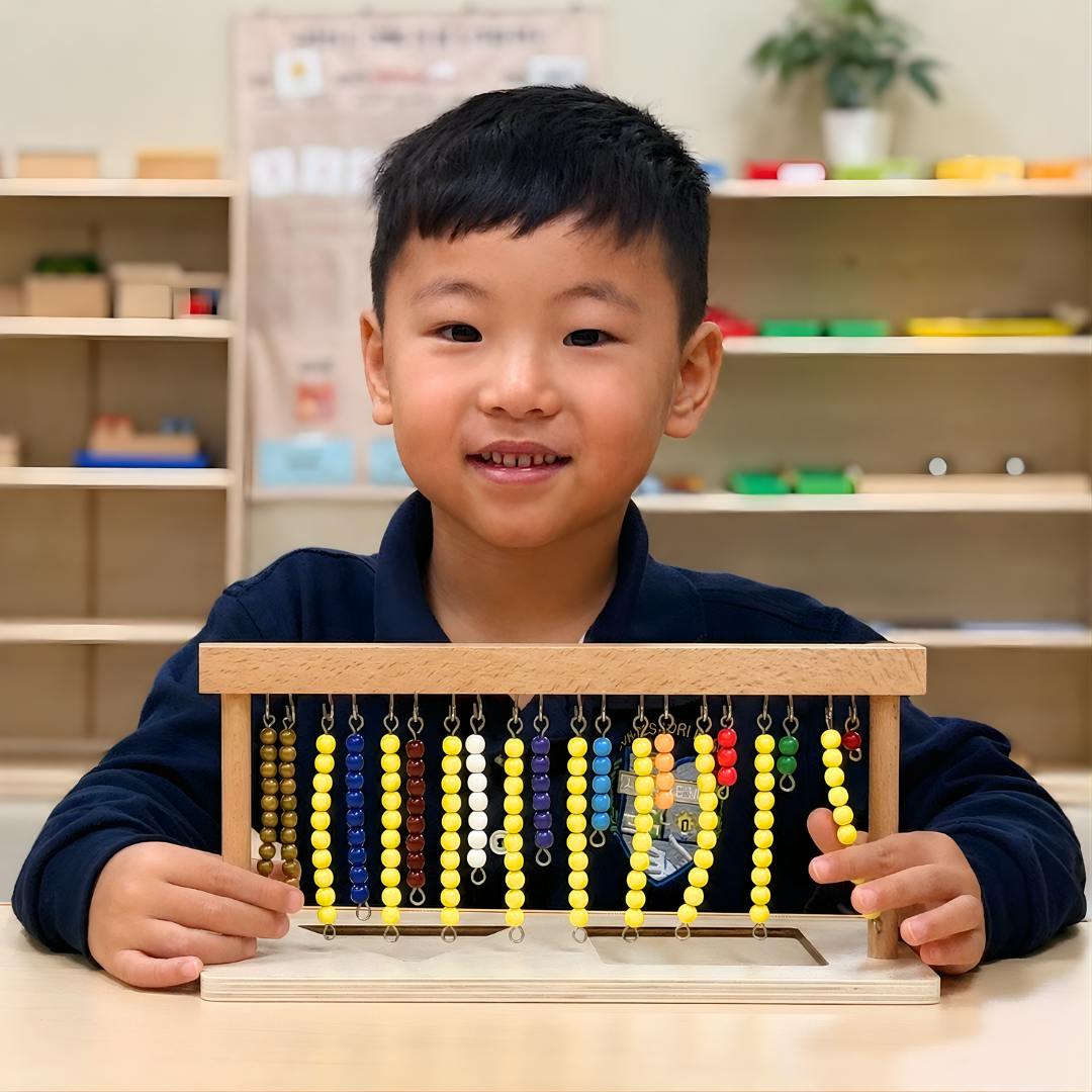 Child smiling and holding an abacus with colorful beads