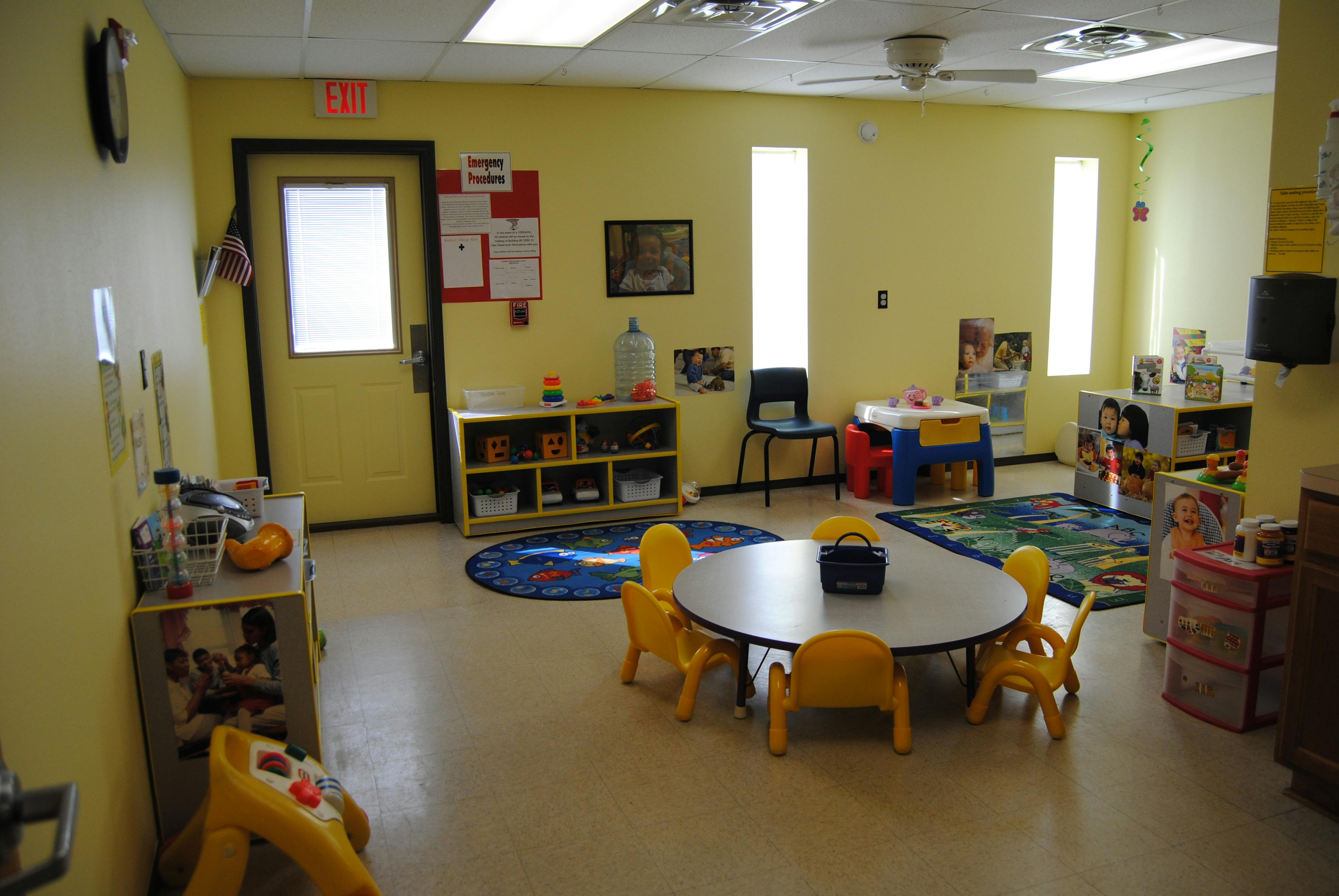 Empty classroom with small tables and chairs