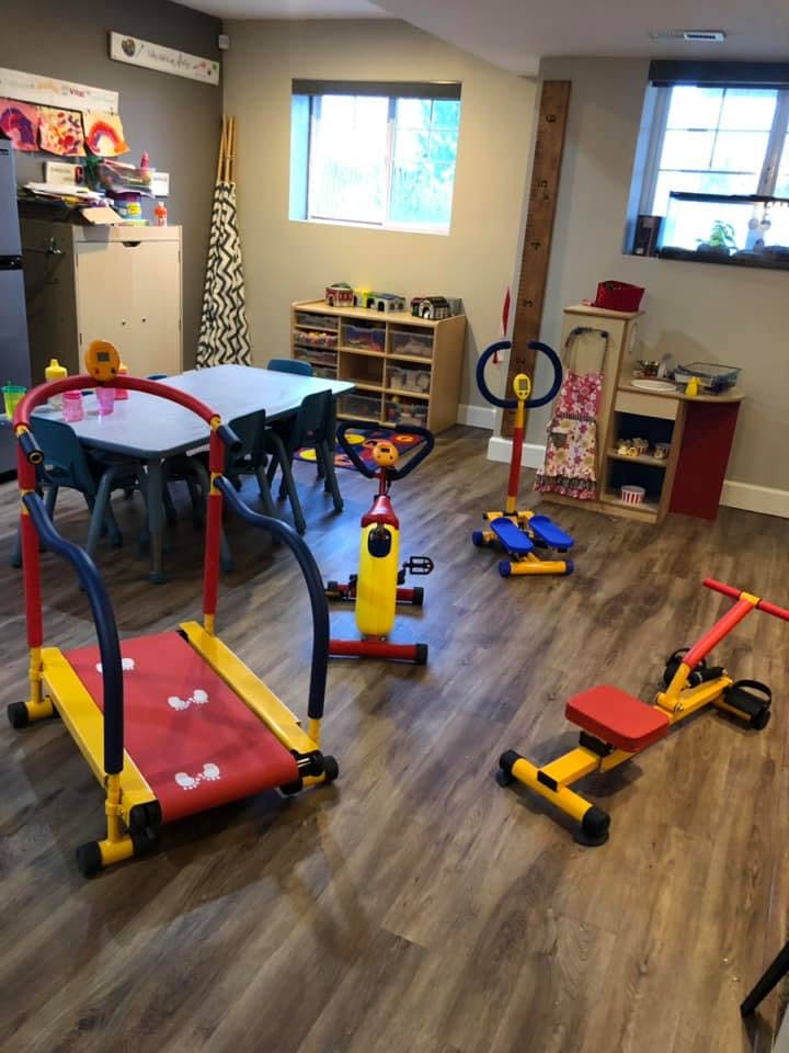 Children's exercise equipment in a room with a table and chairs