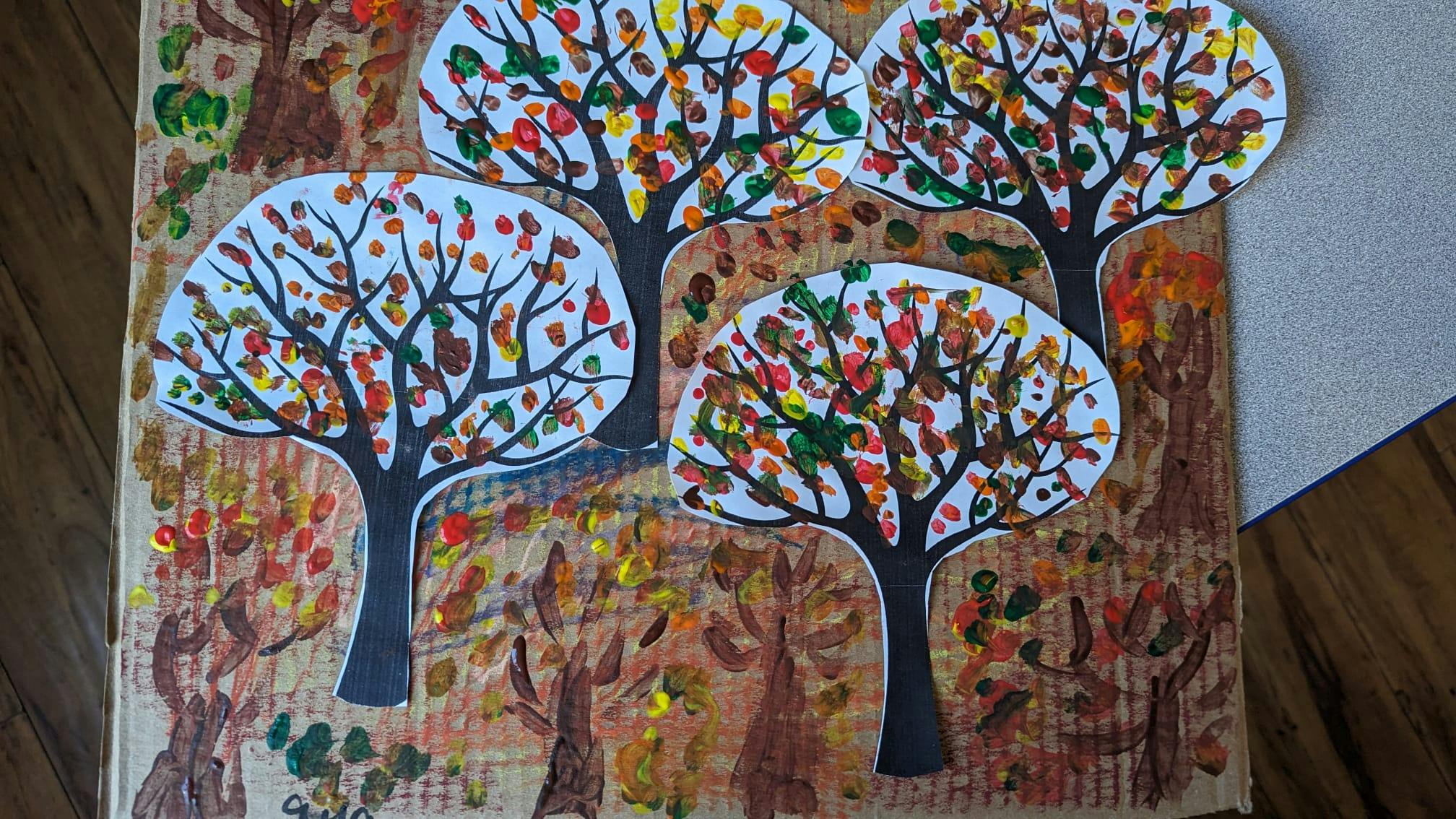 Child's artwork of trees with colorful leaves