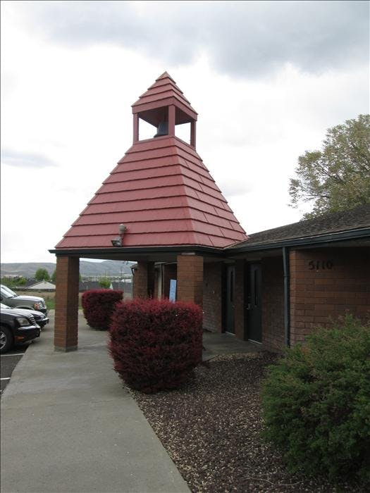 Entrance to a building with a red pagoda-style roof and bell tower