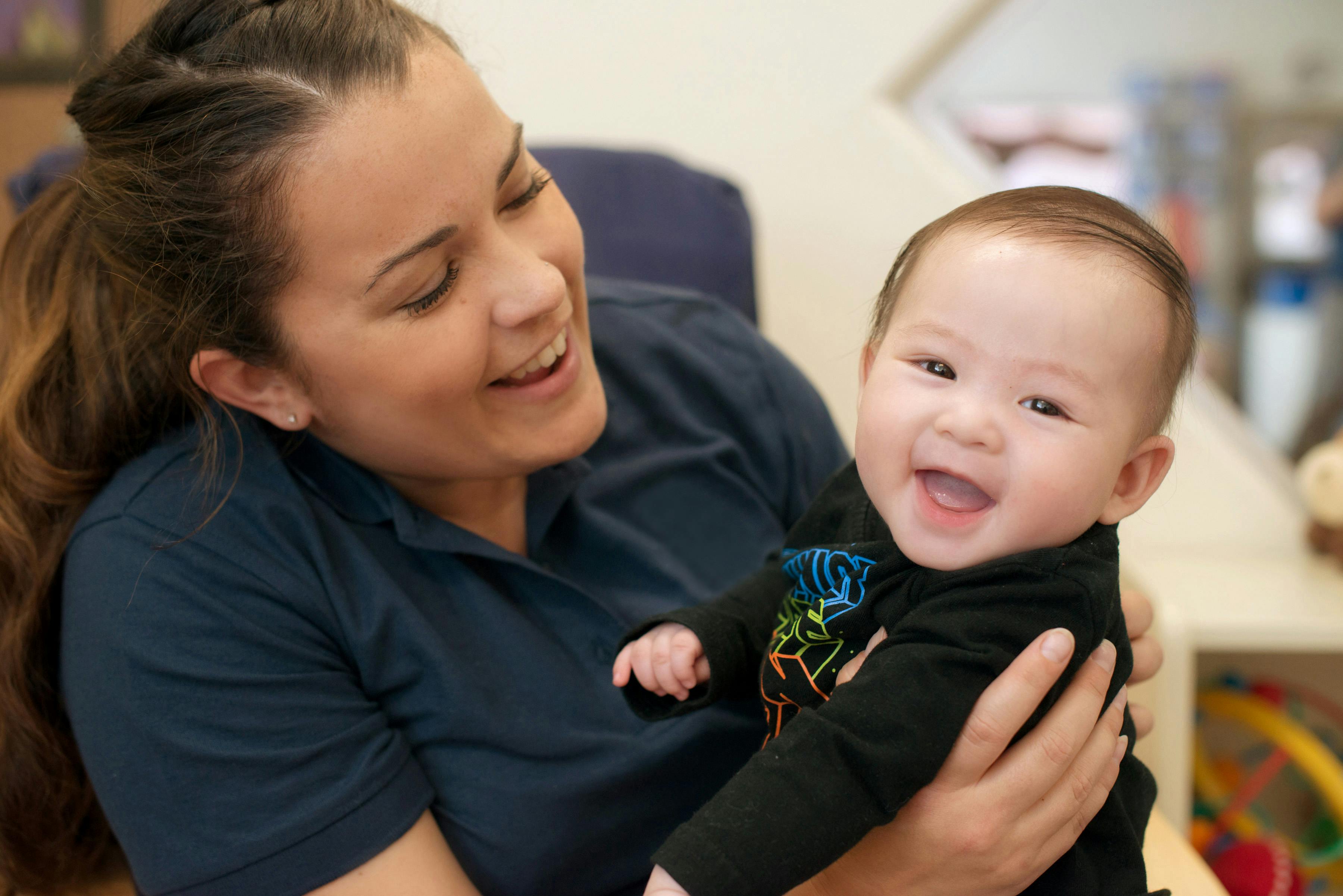 Person holding a smiling child