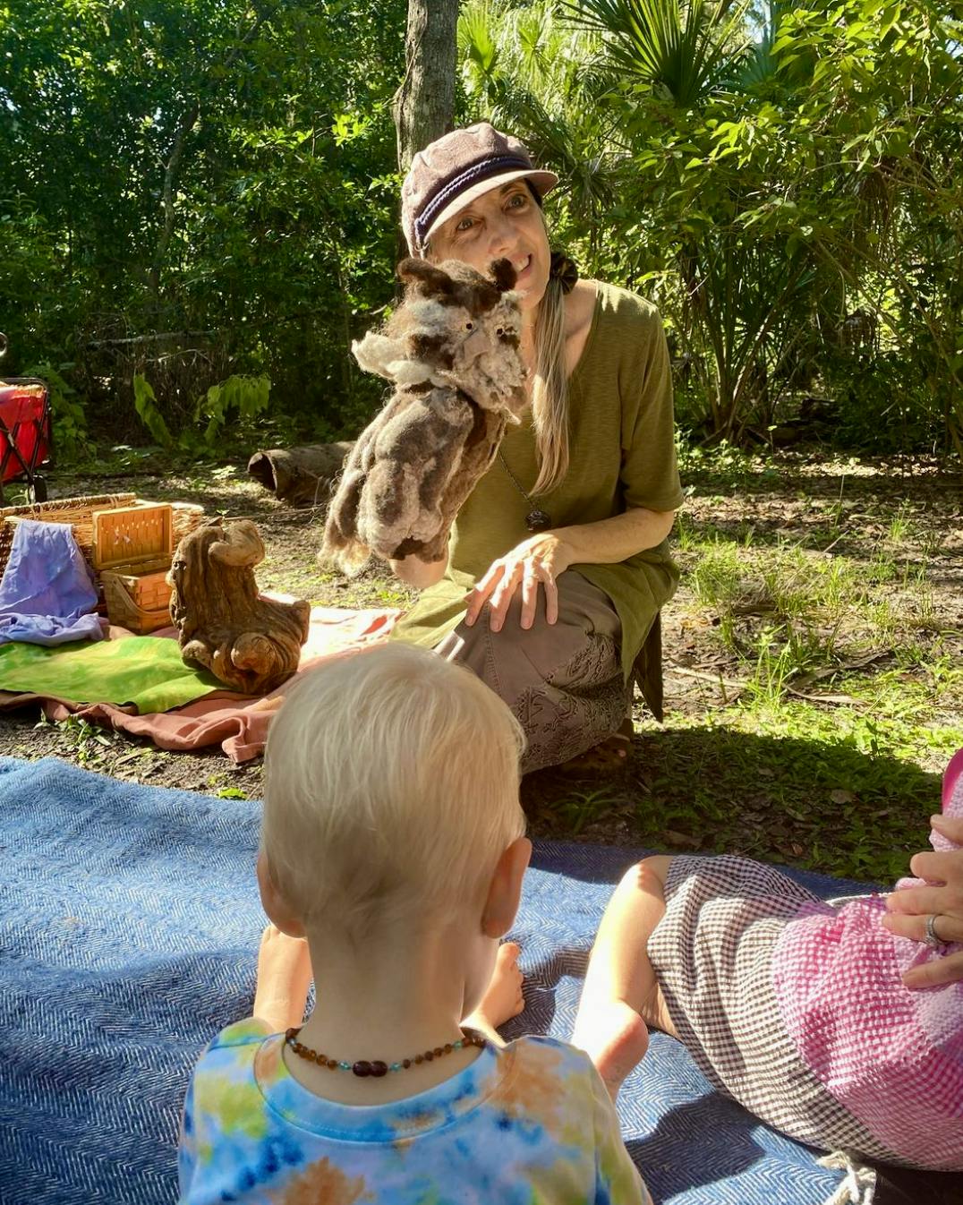 Person with a puppet interacting with children
