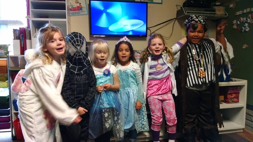 Five children in costumes standing together