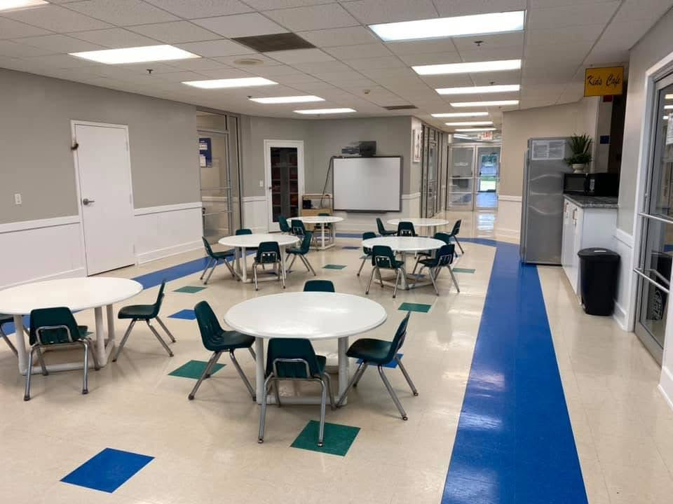 Empty classroom with round tables and chairs