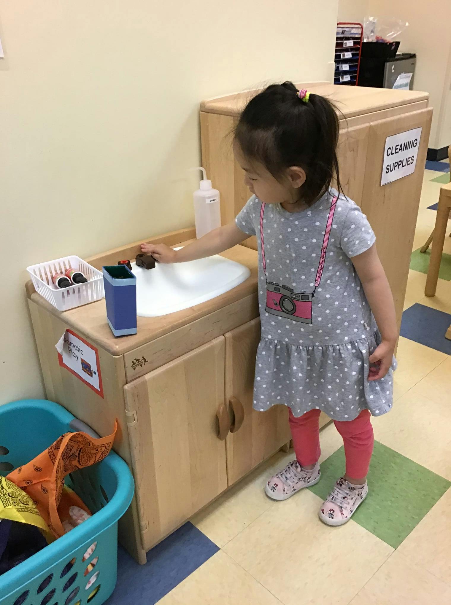 Child playing with a toy sink