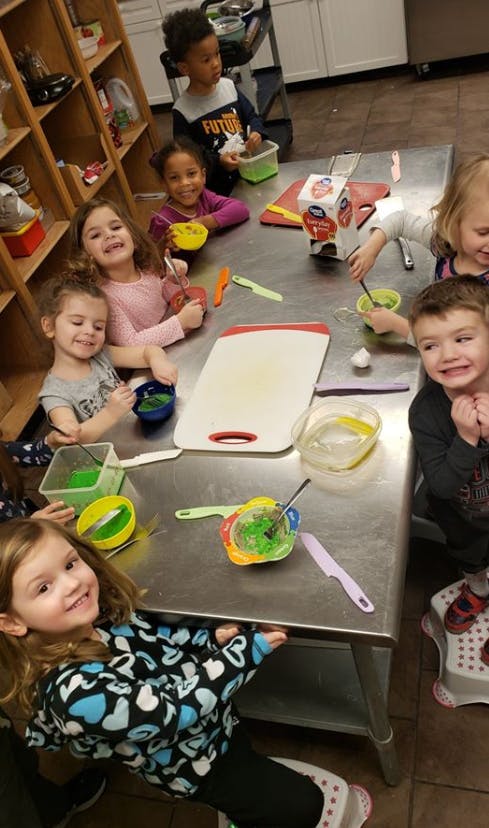 Children at a table with bowls and utensils