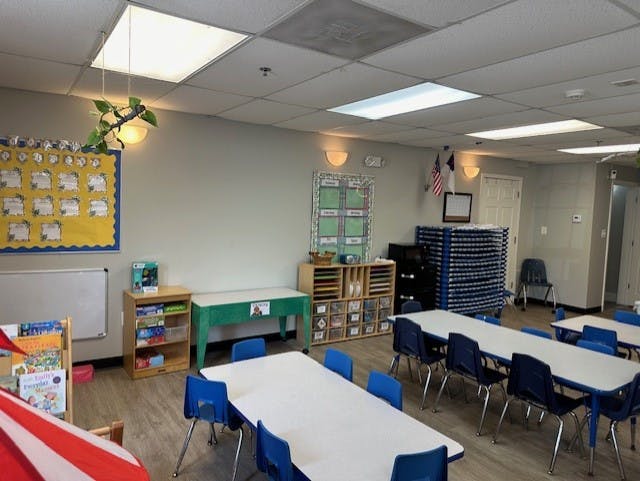Classroom with tables, chairs, and storage units