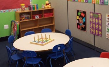 Classroom with a round table and blue chairs