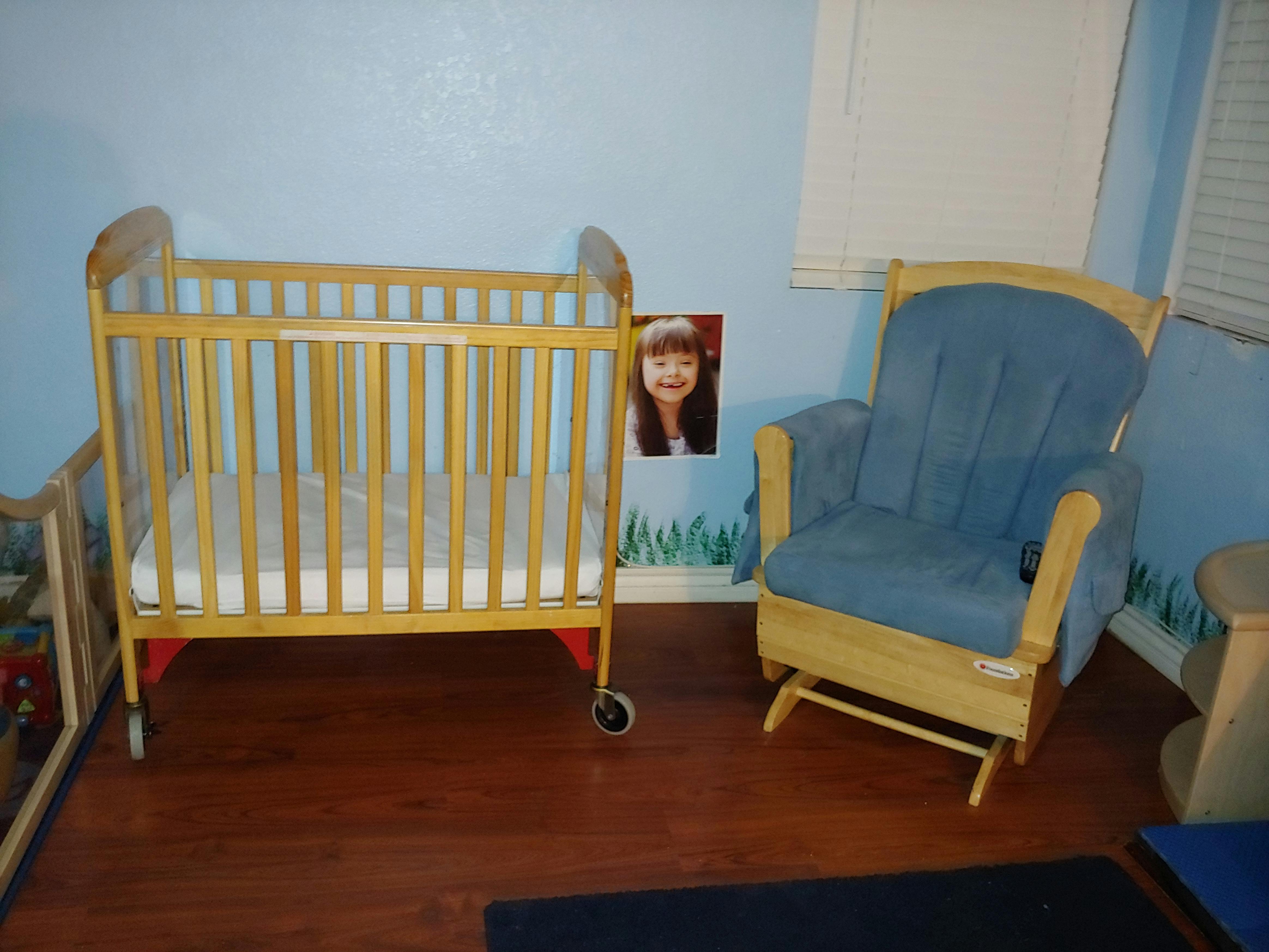 Crib and rocking chair in a room