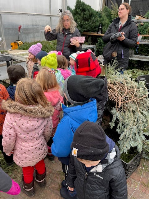 Two adults interacting with a group of children
