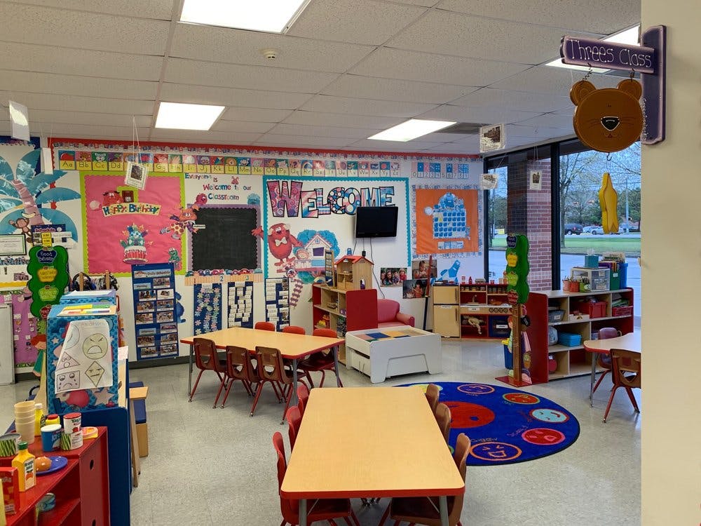 Classroom with tables, chairs, and colorful decorations