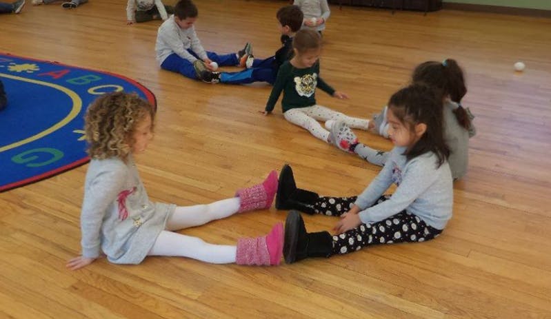 Children sitting on a wooden floor