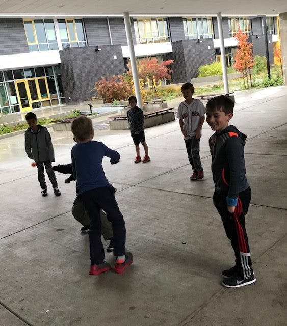 Children playing outdoors on a paved area