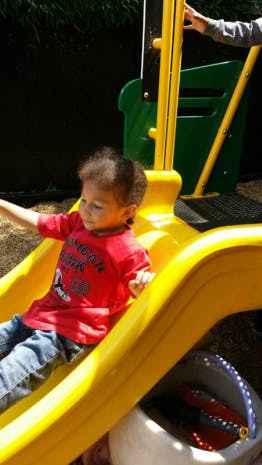 Child on a yellow slide