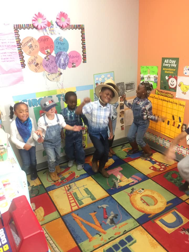 Children dancing in a classroom