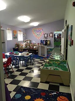 Classroom with tables, chairs, and a checkerboard floor