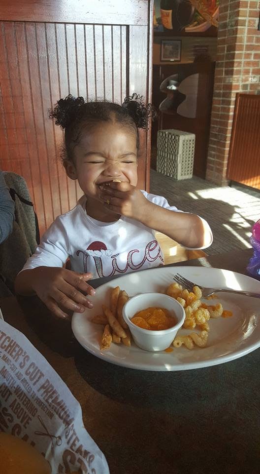 Child eating food at a table