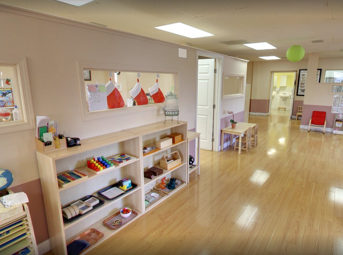 Classroom with shelves of learning materials and small tables